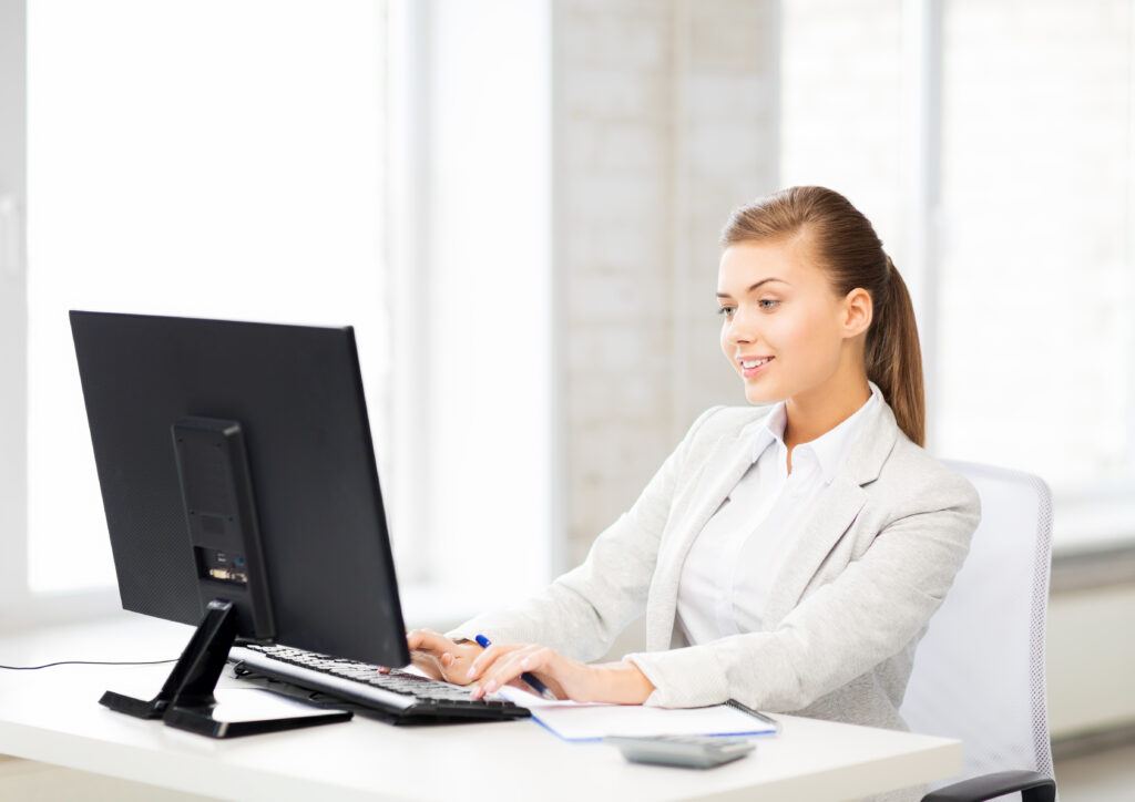 picture of smiling businesswoman with computer in office